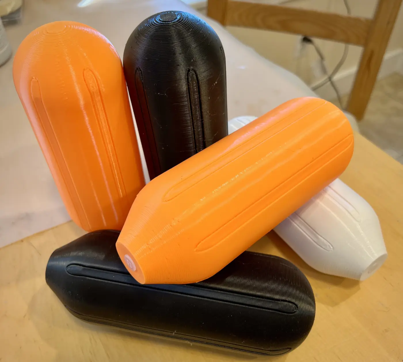 A collection of dog toys I printed laid out on my table. Each dog toy is about 8 inches, and the photo shows the dog toys from several angles